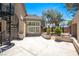 A spacious patio with a spiral staircase and a windowed room with shuttered windows, offering a private outdoor living space at 8800 Cortile Dr, Las Vegas, NV 89134
