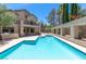 Back of home with a sparkling blue pool, covered patio, and manicured landscaping offers a luxurious outdoor living experience at 8800 Cortile Dr, Las Vegas, NV 89134