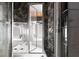 Modern shower with marble tiles, seamless glass door, and modern fixtures at 8800 Cortile Dr, Las Vegas, NV 89134