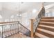 Staircase with carpeted steps and wrought iron railing leading to the upper level at 8800 Cortile Dr, Las Vegas, NV 89134