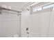 Updated bathroom showcasing white tile, a shower with a window, and a chrome towel rack at 9053 Entrancing Ave, Las Vegas, NV 89149