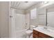 Bright bathroom features a shower-tub combination and large vanity mirror at 9053 Entrancing Ave, Las Vegas, NV 89149