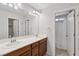 Well-lit bathroom featuring double sinks, large mirror, updated vanity and an open shower at 9053 Entrancing Ave, Las Vegas, NV 89149
