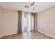 Neutral bedroom featuring wood-look floors, fan and a sliding glass door with coverings at 9053 Entrancing Ave, Las Vegas, NV 89149