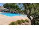 Community pool surrounded by nice plants and trees at 9053 Entrancing Ave, Las Vegas, NV 89149