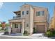 Two-story home featuring stucco exterior, covered porch, and a one-car garage at 9053 Entrancing Ave, Las Vegas, NV 89149
