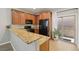 Functional kitchen with wood cabinets, black appliances, and granite countertops at 9053 Entrancing Ave, Las Vegas, NV 89149