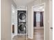 Convenient laundry area with stacked washer and dryer, located near bedroom at 9053 Entrancing Ave, Las Vegas, NV 89149