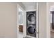 Laundry room featuring a stackable washer and dryer located near the bathroom at 9053 Entrancing Ave, Las Vegas, NV 89149