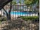 Community pool area with lounge chairs, green grass, and privacy fencing at 9053 Entrancing Ave, Las Vegas, NV 89149