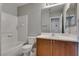 Bathroom with wood cabinets, a shower-tub combo with white tiles, and a vanity at 9140 Entrancing Ave, Las Vegas, NV 89149