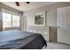 Bedroom featuring a dresser with a mirror, as well as a bed with a tufted headboard at 9140 Entrancing Ave, Las Vegas, NV 89149