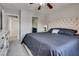 Bedroom featuring a bed with a tufted headboard, and a dresser with a mirror above it at 9140 Entrancing Ave, Las Vegas, NV 89149