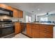 Bright kitchen includes stainless steel appliances, wooden cabinets, and backyard access at 9140 Entrancing Ave, Las Vegas, NV 89149