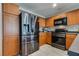 Kitchen with wood cabinets, stainless steel appliances, and a gray countertop with tile floors at 9140 Entrancing Ave, Las Vegas, NV 89149