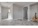 Living room with bright grey paint, stone floors, and built-in shelves at 9140 Entrancing Ave, Las Vegas, NV 89149