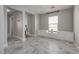 Living room with bright grey paint, stone floors, and built-in shelves at 9140 Entrancing Ave, Las Vegas, NV 89149