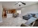 Open-concept living area features gray tile flooring and a comfortable sectional sofa with throw pillows at 9140 Entrancing Ave, Las Vegas, NV 89149