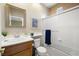 Bathroom with a single sink vanity, a toilet, and a shower with sliding glass doors, all neatly arranged at 939 Paisley St, Las Vegas, NV 89145