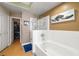 Bright bathroom featuring a tub with tile surround, glass shower doors, and modern fixtures, creating a luxurious feel at 939 Paisley St, Las Vegas, NV 89145