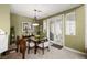 Dining area features neutral color scheme, chandelier, and access to the backyard at 939 Paisley St, Las Vegas, NV 89145