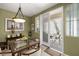 Dining room featuring modern lighting fixture and access to outdoor patio at 939 Paisley St, Las Vegas, NV 89145