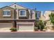 Townhouse shows brick accents and attached garages for convenient parking at 939 Paisley St, Las Vegas, NV 89145