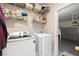 Well-equipped laundry room with modern washer and dryer, plus shelving for storage at 939 Paisley St, Las Vegas, NV 89145