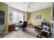 Bright home office with a large window, ceiling fan, desk, and comfortable seating arrangement at 939 Paisley St, Las Vegas, NV 89145