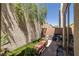 Relaxing patio area with brick flooring, comfortable seating, and well-maintained landscaping at 939 Paisley St, Las Vegas, NV 89145
