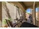 Inviting outdoor patio with comfortable seating and a table, perfect for enjoying the lush greenery at 939 Paisley St, Las Vegas, NV 89145