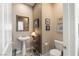 Cozy powder room with pedestal sink, framed mirror, and modern fixtures at 939 Paisley St, Las Vegas, NV 89145