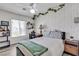 Comfortable bedroom with a ceiling fan, green leafy vines, natural light, and a desk area at 9585 Teton Diablo Ave, Las Vegas, NV 89117