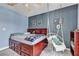 Comfortable bedroom with a unique hanging chair, hardwood floors, and neutral walls at 9585 Teton Diablo Ave, Las Vegas, NV 89117