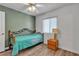 Comfortable bedroom featuring wood floors, a side table, and a cozy atmosphere at 9585 Teton Diablo Ave, Las Vegas, NV 89117