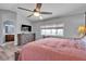 Light and bright primary bedroom featuring a ceiling fan and access to a modern bathroom at 9585 Teton Diablo Ave, Las Vegas, NV 89117