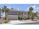 Exterior view of home featuring desert landscaping, mature trees, and attached garage at 9585 Teton Diablo Ave, Las Vegas, NV 89117