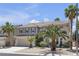 Two-story home with a three car garage and desert landscaping at 9585 Teton Diablo Ave, Las Vegas, NV 89117