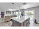 Kitchen area with island featuring bar stool seating, stainless appliances, and sliding doors to backyard at 9585 Teton Diablo Ave, Las Vegas, NV 89117