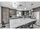 Updated kitchen with large marble island, dark cabinets, and stainless steel appliances at 9585 Teton Diablo Ave, Las Vegas, NV 89117
