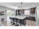 Renovated kitchen featuring a large island with seating, stainless appliances, and sliding doors to the yard at 9585 Teton Diablo Ave, Las Vegas, NV 89117