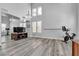 Spacious living room with high ceilings, a wall mirror, and wood-look floors at 9585 Teton Diablo Ave, Las Vegas, NV 89117