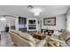 Cozy living room features a fireplace, tv, hardwood floors, and comfortable leather seating at 9585 Teton Diablo Ave, Las Vegas, NV 89117
