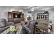 Cozy living room featuring a large entertainment center, hardwood floors, and ample seating at 9585 Teton Diablo Ave, Las Vegas, NV 89117