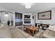 Inviting living room with modern decor featuring a fireplace, television, and hardwood flooring at 9585 Teton Diablo Ave, Las Vegas, NV 89117