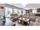 Open concept living room features large windows overlooking backyard and comfortable leather seating at 9585 Teton Diablo Ave, Las Vegas, NV 89117