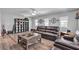 Bright living room featuring hardwood floors, a comfortable sofa, and natural light at 9585 Teton Diablo Ave, Las Vegas, NV 89117
