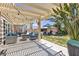 Inviting outdoor patio with stylish furniture, pergola, and string lights for relaxing or entertaining at 9585 Teton Diablo Ave, Las Vegas, NV 89117