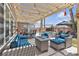 Charming covered patio with comfortable seating, string lights, and views of the sparkling pool at 9585 Teton Diablo Ave, Las Vegas, NV 89117