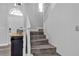 Elegant staircase with white banister and wood-look steps, leading to the upper level at 9585 Teton Diablo Ave, Las Vegas, NV 89117